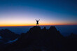 © romanets_v - Triumphant silhouette of young hispanic male on mountain summit at sunset