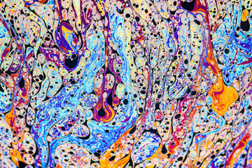Wall Mural - Real photograph of a colorful light interference on a soap bubble surface with random swirls, curves and lines