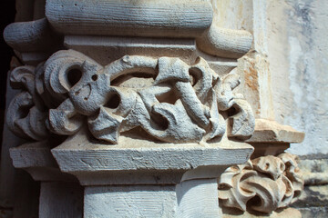 Wall Mural - close-up of an intricately carved stone capital featuring a stylized floral motif, 