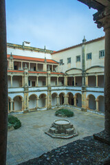 Wall Mural - monastery courtyard, revealing intricate architectural details such as arched cloisters, ornate columns