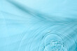 © New Africa - Rippled surface of clear water on light blue background, top view