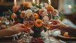 © AspctStyle - Couple toasting with glasses of wine at romantic dinner table with a bouquet of roses in the background. Valentine Day and celebration concept. Design for greeting card, poster, invitation, and header
