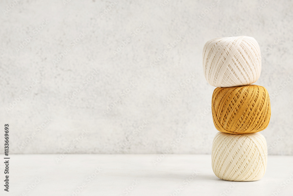 Colorful knitting yarn on light grunge background