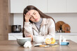© Pixel-Shot - Ill young woman with headache in kitchen