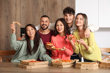 Wall Mural - Group of friends with tasty pepperoni pizza in kitchen