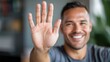 © maesarin - Headshot portrait of a confident and friendly male business professional making a hand gesture while smiling in a casual corporate office environment