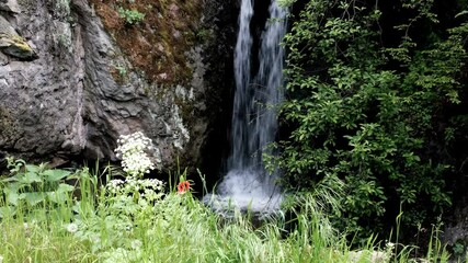 Wall Mural - Tripod shot of waterfall between Sanahin and Akner villages on sunny summer day. Armenia.