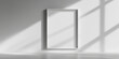 © smth.design - Minimalistic white picture frame on a sunlit wall with shadow patterns
