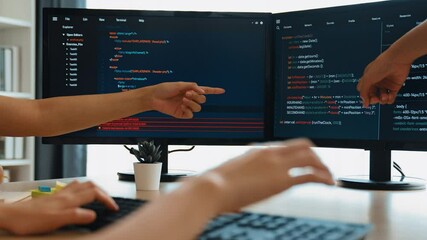 Slow motion back end software developer engineer for computer programming working together on debugging writing computing code, solving complex algorithms display on monitor in office. Burgeoning
