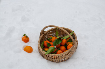 Wall Mural - Christmas basket with fruit tangerines pineapple. New Year or Christmas food sale. Snow and bokeh. mandartny basket snow