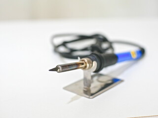 close-up of a soldering iron on a white background