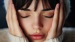 © Dragon42 - Peaceful Portrait of a Young Woman with Closed Eyes and Hands on Face in Cozy Knit Sweater