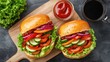 © Pc - Two gourmet sandwiches with fresh vegetables, served on a wooden board with ketchup and coffee.