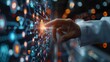 © Azis Stock - Hand touches glowing digital screen with complex data display.