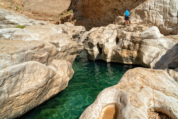 Wall Mural - Oman. Oasis Wadi Bani Khalid. Lagoon with fresh emerald water and beautiful rocks