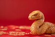 © Duckai - Copy Space of a Wooden Snake Handicraft Figure with Red Background Highlighting 2025 Lunar New Year and Traditional Chinese Craft
