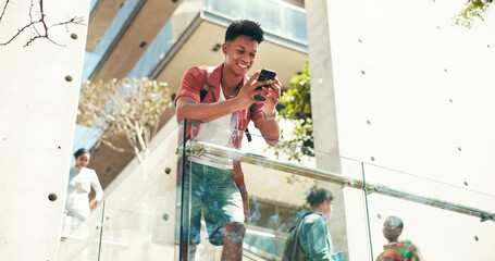 Poster - Phone, happy student and man at university outdoor for schedule, learning or online education. Smile, mobile and person at college campus to check test results, research or reading text in low angle