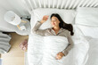 © Home-stock - Top view of calm lady sleeping well on her back, resting, enjoying fresh cotton bedding, soft pillow and comfy mattress, copy space, banner