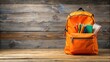 © lapeepon - Orange backpack filled with school supplies on a wooden table , back to school, backpack, orange, school supplies, education