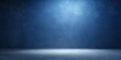 © InspireStock Gallery - A single spotlight illuminates the center of a textured blue wall, casting a soft glow on the empty concrete floor, creating a minimalist and dramatic backdrop for any composition.