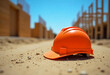 © Oleksii - A orange safety helmet or hardhat for the construction worker which is placed on the ground of construction working site