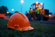 © Oleksii - A orange safety helmet or hardhat for the construction worker which is placed on the ground of construction working site