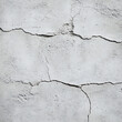 © Alex - Close-up view of a cracked and textured concrete wall, showcasing its rough quality.