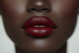 Extreme close-up of a african woman’s face with bold red lips and glowing skin. beautiful lips with red lipstick.