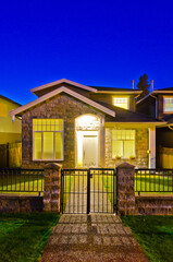 Wall Mural - Entrance of luxury house with nice green Summer landscape at night in Vancouver, Canada, North America. June 2024.