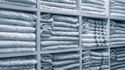Leinwandbilder - A white shelf with many white towels stacked on top of each other. The towels are folded and stacked in different ways