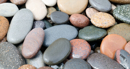 Aufkleber - A pile of rocks with different colors. Some are gray, some are brown, and some are red as background