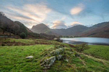 Wall Mural - Beautiful Autumn sunrise landscape image of Buttermere in Lake District with Fleetwith Pike and Haystacks mountains