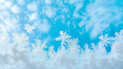 Wall Mural - Snowflakes gently falling under a clear blue sky