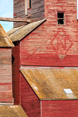 Wall Mural - A red and yellow building with a lot of wood and a lot of rust