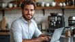 © aekkorn - My secret to success Good coffee. Cropped portrait of a handsome young businessman working on his laptop while sitting in the kitchen at home.