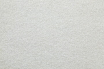 white cuddle teddy bear fabric as background, top view