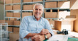 © peopleimages.com - Business, logistics and portrait with mature man in office for delivery, distribution or planning. Ecommerce, shipping and smile of happy employee in workplace for export or supply chain management