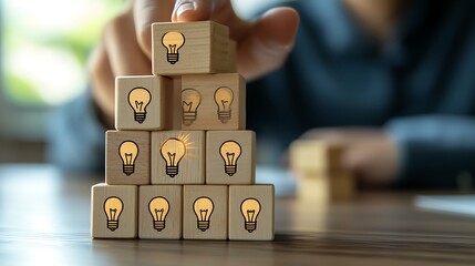 Hand stacking wooden blocks with human head icons
