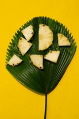 Wall Mural - Fresh pineapple on green leaves