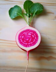 Wall Mural - Vibrant pink radish with lush green leaves, a healthy and beautiful food.