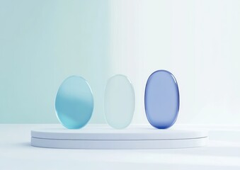 Aufkleber - Three smooth translucent oval stones on a white platform with soft lighting.