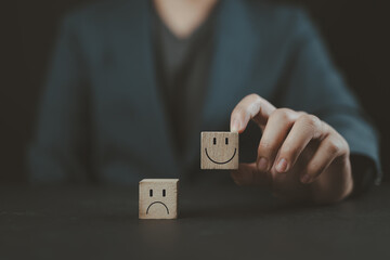 Wall Mural - customer service review. client holds a smiley happy face on wooden cube with text review symbol. fe