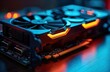 © Pete - High-tech graphics card for gaming, crypto mining. Modern device with vibrant orange, blue lights. Powerful tech component for computer. Performance focused. Ideal for professional use extreme