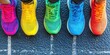 © HIRA STOCK - Four pairs of colorful running shoes at the starting line, ready for a race, fitness and competition concept