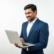 © Alper AI - A businessman wearing a blue suit, standing with an open laptop in his hands, surfing the internet with a smile, studio shot, isolated on a white background.