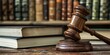 © Eyepain - wooden gavel rests on a desk beside stacked law books, symbolizing justice authority and legal practice.
