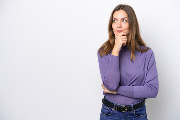 Wall Mural - Young caucasian woman isolated on white background thinking an idea while looking up