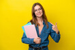 © luismolinero - Young student caucasian woman isolated on yellow background giving a thumbs up gesture