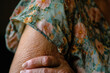 © Ricky - closeup of older woman's hand holding arm,  crepey skin, beauty wearing floral dress