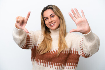 Wall Mural - Young caucasian woman isolated on white background counting seven with fingers